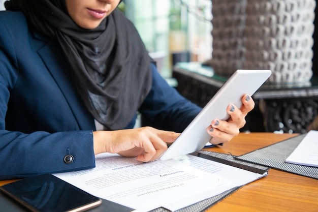 businesswoman reading contract and consulting internet